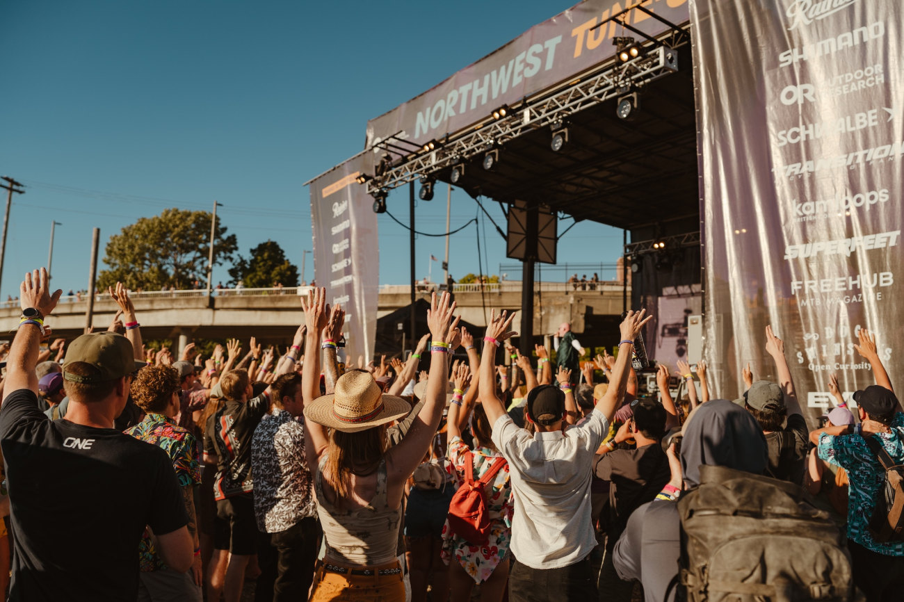 A person holds their phone up during a concert.